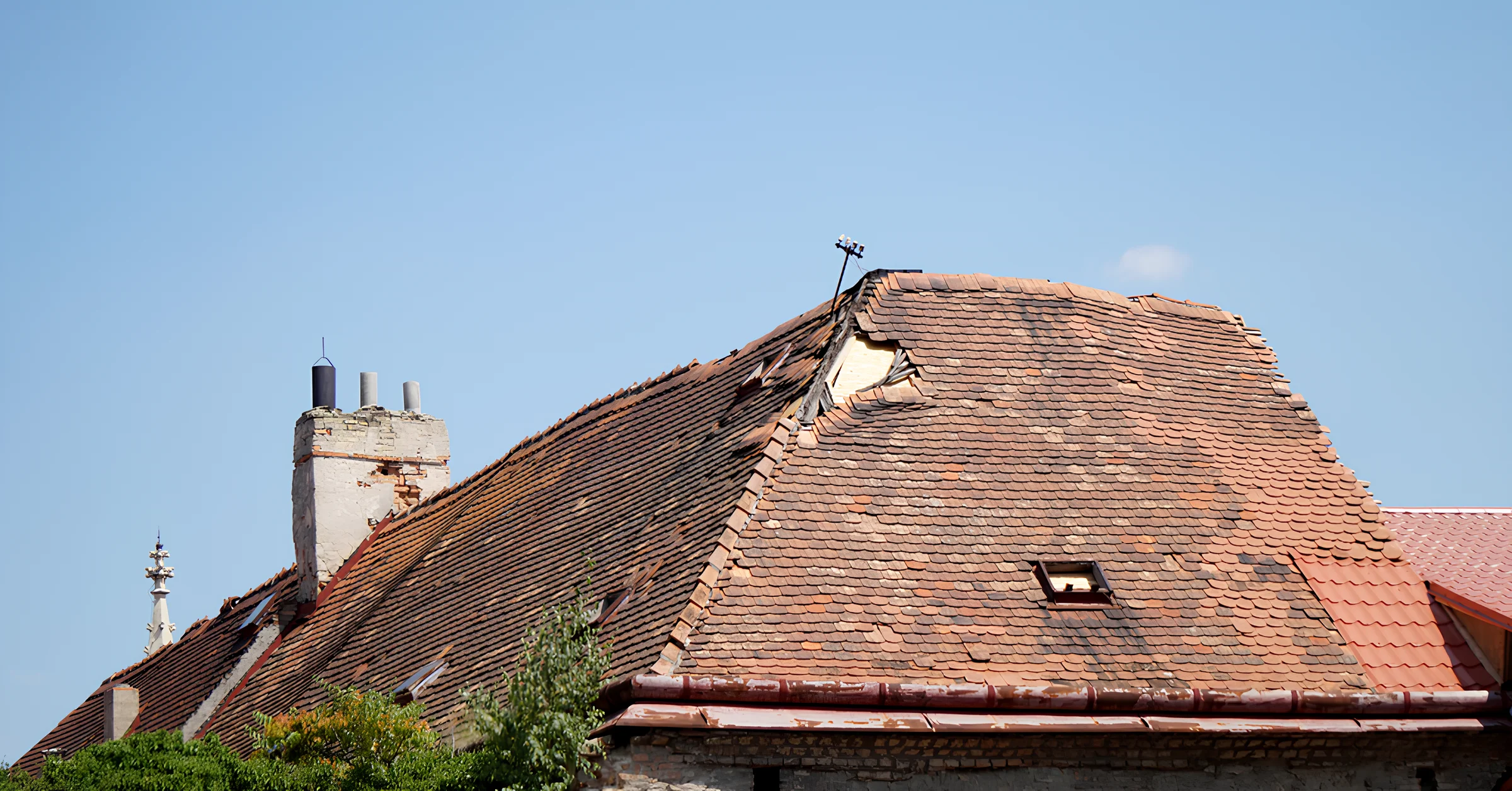 Image of a damaged roof needing a storm damage assessment.